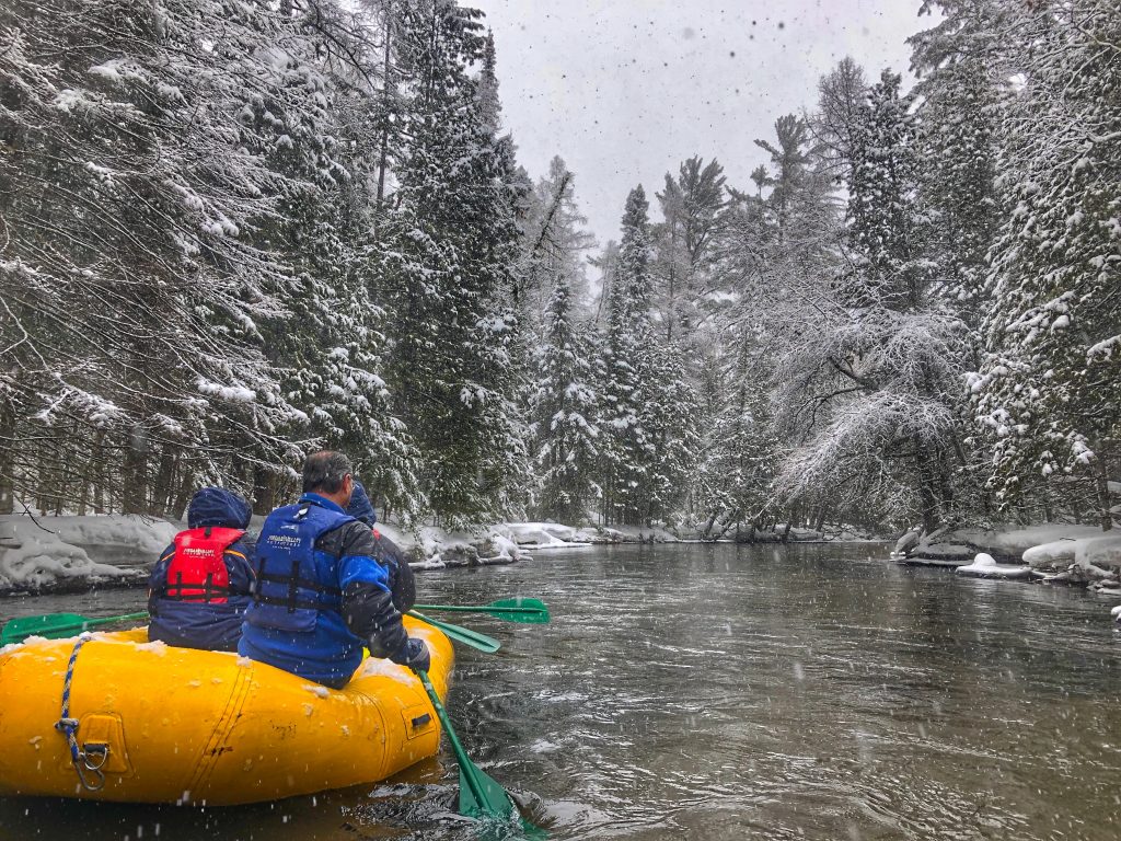 winter rafting down a river in northern michigan.